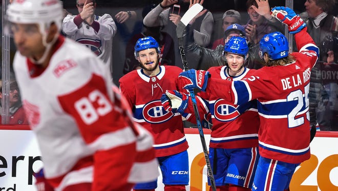The Canadiens' Paul Byron, center, celebrates his third goal of the game in the second period with teammates Victor Mete and Jacob de la Rose, right, during the Wings' 10-1 loss Saturday, Dec. 2, 2017, in Montreal.