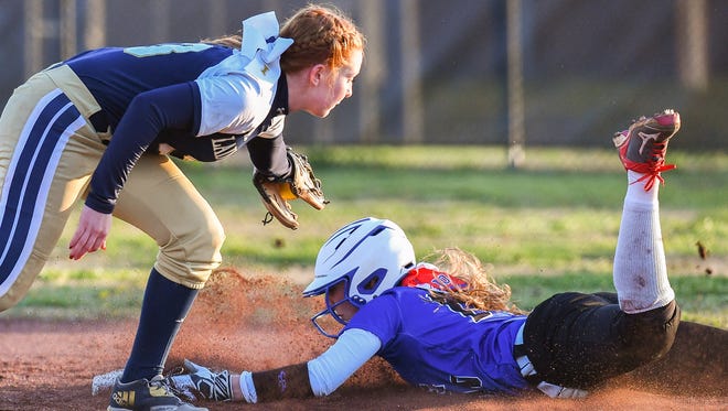 Page's Jenna Johnson (10) is tagged out on a stolen base attempt by Independence's Makinlee Webb (13) during the fifth inning at Page High School, Wednesday, March 21, 2018, in Franklin, Tenn.