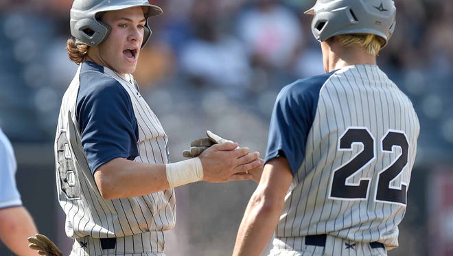 St. Andrew's David DuCote (8) gets congratulations from Dickson Ray (22) after scoring against North Pontotoc on Tuesday, May 15, 2015, in the MHSAA State Baseball Championships at Trustmark Park in Pearl, Miss.