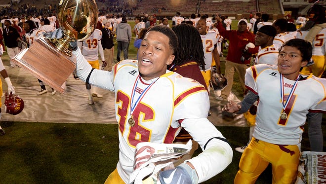 Lanceton Evans (36) and the Laurel Tornadoes celebrate their thrilling 29-26 victory over Oxford in the MHSAA Class 5A football state championships on Saturday, December 6, 2014, at Davis Wade Stadium on the Mississippi State University campus in Starkville.