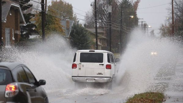 A van splashes through a puddle on Kimbrough Avenue on Tuesday, Nov. 17, 2015.