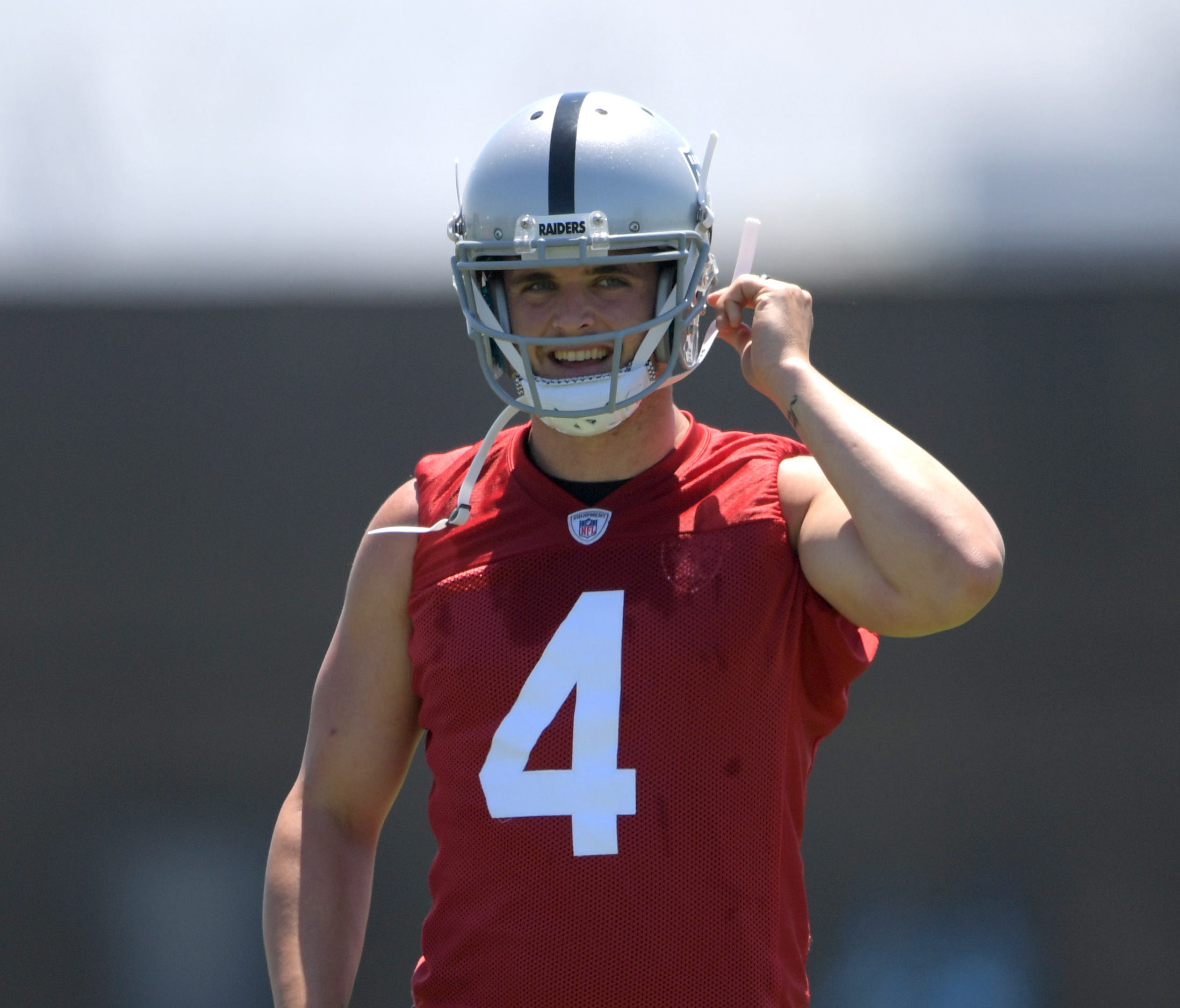 Oakland Raiders quarterback Derek Carr (4) reacts during organized team activities at the Raiders practice facility.