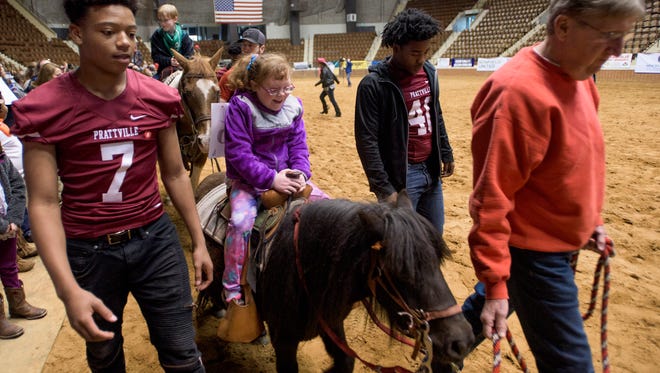 Children and their families attend the Miracle Rodeo at Garrett Coliseum in Montgomery, Ala., on Wednesday March 15, 2017. The SLE Rodeo will be held from Thursday the 16th to Saturday the 18th.