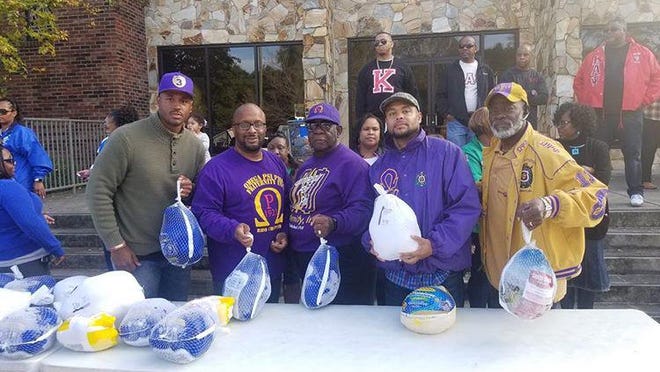 Brothers of the Epsilon Upsilon Chapter of the Omega Psi Phi fraternity are shown serving at the Turkey Drive and giveaway held Nov. 18, 2019, in Gastonia. Epsilon Upsilon was able to donate 35 turkeys to the drive.