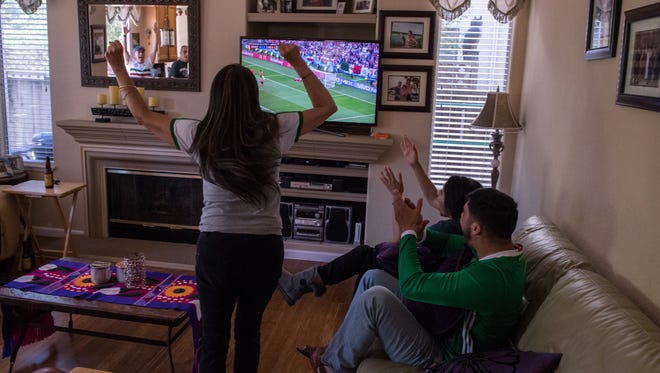 Locals pile in to a home near McKinnon Park in Salinas to watch the 2018 World Cup and cheer on Mexico.