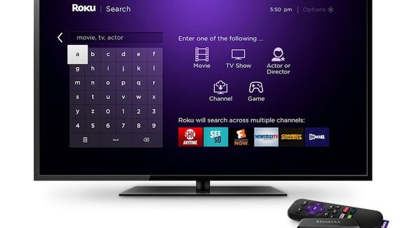 TV displaying Roku's streaming interface displayed on a television with Roku streaming stick nearby