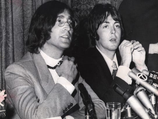 John Lennon, left, and Paul McCartney flew to New York
