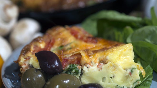 Eggs, onions, green peppers, mushrooms and spinach baked together in the oven as a Frittata for a light but fill meal.