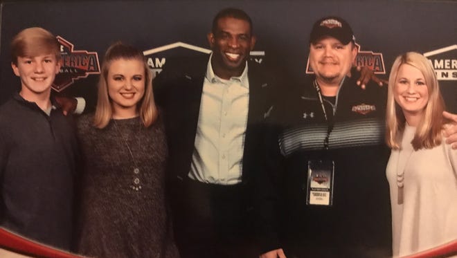 Parkway coach Neil May (second from right), pictured here with his family and head coach Deion Sanders, coached in the 2018 Under Armour All-America game.