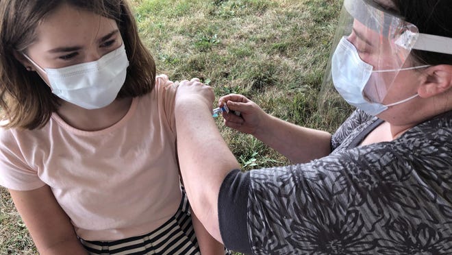 Marshwood Middle School student Lucinda Cox gets a flu shot from Sarah Gay, registered nurse, of Nurses from Northern Light Home Care. The immunization was offered to students, staff and the community on Monday afternoon.