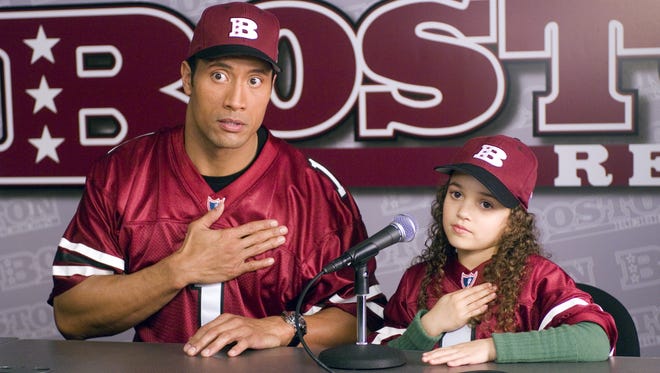 Dwayne Johnson plays the quarterback dad and Madison Pettis is his daughter in "The Game Plan."