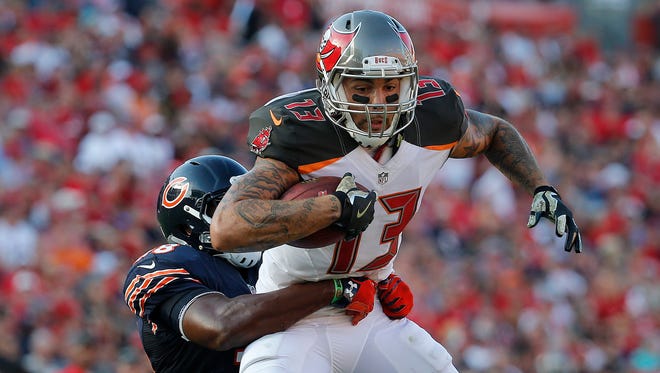 Tampa Bay Buccaneers wide receiver Mike Evans (13) runs with the ball as Chicago Bears free safety Adrian Amos (38) defends during the second half at Raymond James Stadium.