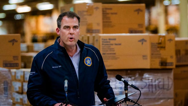 Gov. Kevin Stitt speaks Tuesday from a warehouse holding Oklahoma's supplies to fight COVID019.
