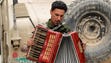 An Iraqi soldier plays with an accordion found on the