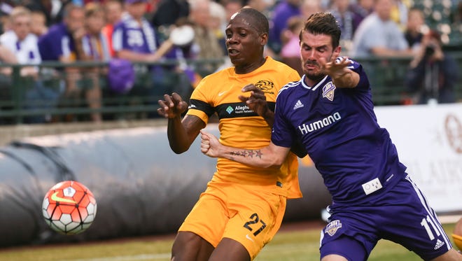 Louisville City FC’s Niall McCabe, #11, battles Pittsburgh Riverhounds’ Romeo Parkes, #27, during their match at Slugger Field.Apr. 27, 2016