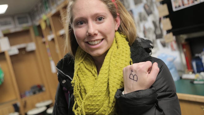 Madeline Buckley shows off the “B+” she writes on her left hand every day to remind her that she is “in the service of others.”