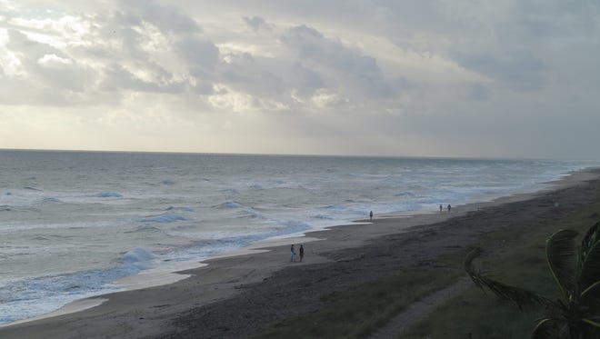 A few beachgoers already are on the sands at Jensen Beach at 8:34 a.m. Saturday morning, but it's not a great day to be in the water. The surf already is kicking up.