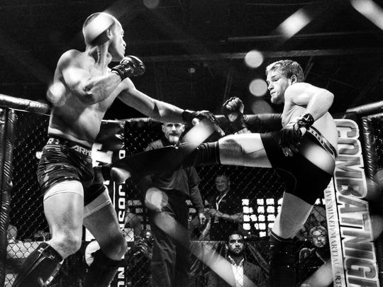 Brett Hirst kicks at Brian Basford during an MMA fight