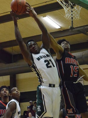 Rapides' Dorian Blue (21, left) comes up with a rebound against Many's Jeffrey Frazier (15, right).