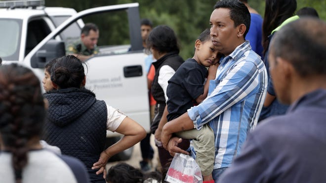 Families who crossed the nearby U.S.-Mexico border near McAllen, Texas, wait for Border Patrol agents to check names and documents. Immigration authorities say they expect the ongoing surge of Central American families crossing the border to multiply in the coming months.