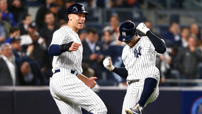 New York Yankees right fielder Aaron Judge (99) and New York Yankees shortstop Didi Gregorius (18) celebrate after scoring in the fifth inning against the Minnesota Twins at Yankee Stadium.