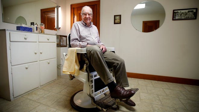 Clarence Zahringer, 99, sits in his barber chair at his home in Sherwood. He's been cutting hair since the 1940s.