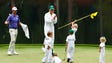 Webb Simpson reacts as his children play with Bubba