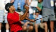 Tiger Woods celebrates after making a birdie on the