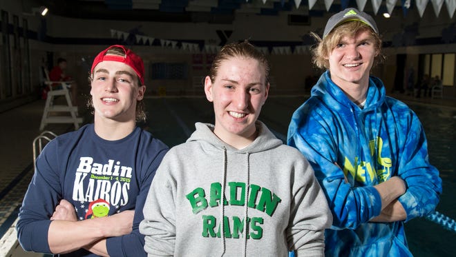 Badin High School swimmers (left to right) Jack Vonsteenkiste, Allison Schoster and Michael Nye pose by the pool at the Fitton Family YMCA in Hamilton, Ohio, on Tuesday, Feb. 9, 2016. Badin High School is attempting to qualify swimmers for the state tournament, despite having limited resources and training time.