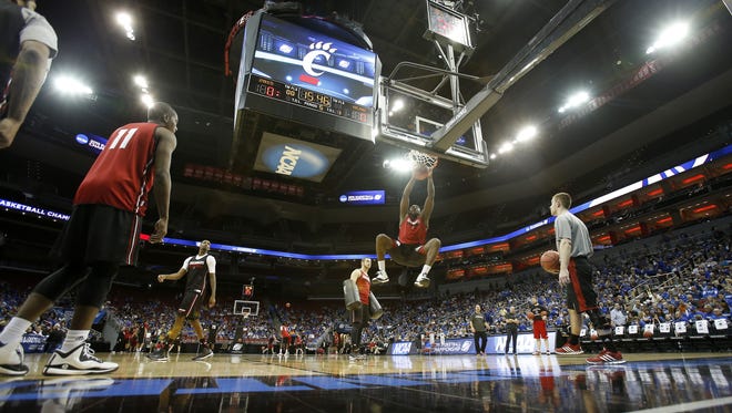 UC junior forward Coreontae DeBerry dunks during practice on Wednesday at the KFC Yum! Center in Louisville.