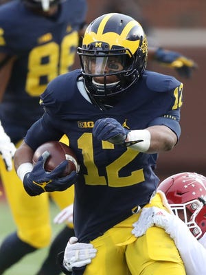 University of Michigan Wolverine's Chris Evans is tackled by the Indiana Hoosier's Marcus Oliver during first half action Saturday, November 19, 2016 at Michigan Stadium in Ann Arbor MI.
