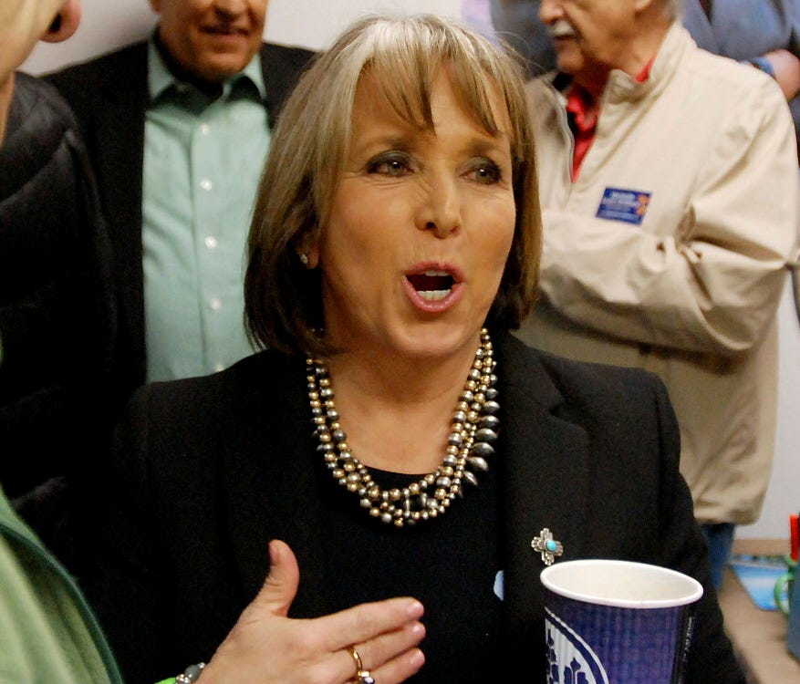 Democratic Congresswoman and gubernatorial candidate Michelle Lujan Grisham talks to political supporters and campaign volunteers at the opening of a campaign office in Santa Fe, N.M., on April 6, 2018.