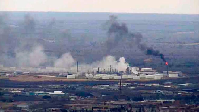 This image from video provided by WDIO-TV in Duluth shows smoke rising from the Husky Energy oil refinery after an explosion Thursday morning, April 26, 2018 in Superior, Wis. Authorities say several people were injured in the explosion. (WDIO-TV via AP)