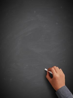 Hand writing on blank chalkboard