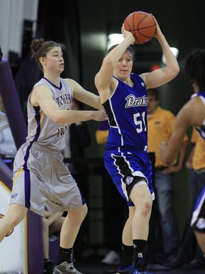 Drake forward Cara Lutes (right) looks to pass out of the lane as UNI defender Jen Keitel plays defense during a women's basketball game last season.