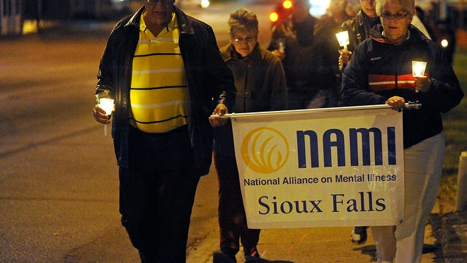 Wayne and Phyllis Arends lead the National Alliance on Mental Illness Walk in Sioux Falls in this file photo.