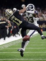 Rams defensive back Nickell Robey-Coleman (23) drills Saints wide receiver Tommylee Lewis during a third-down pass near the end of last month's NFC Championship Game. A referee who has local ties has come under fire for not calling pass interference on the play. (Photo: Gerald Herbert/AP)