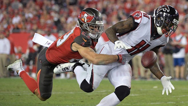 Tampa Bay Buccaneers free safety Chris Conte (23) breaks up a pass intended for Atlanta Falcons wide receiver Julio Jones (11) during the second half of an NFL football game Monday, Dec. 18, 2017, in Tampa, Fla. The Falcons won 24-21. (AP Photo/Phelan M. Ebenhack)