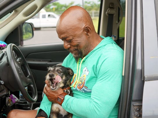 Big Island evacuee Sammy Walton pets his dog, Sugar,