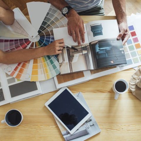 Couple looking at paint samples and other remodeli