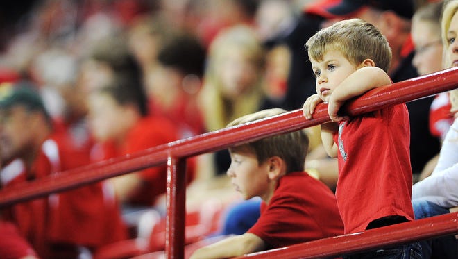 A young USD fan looks on during the first half of a game against North Dakota State in 2014.