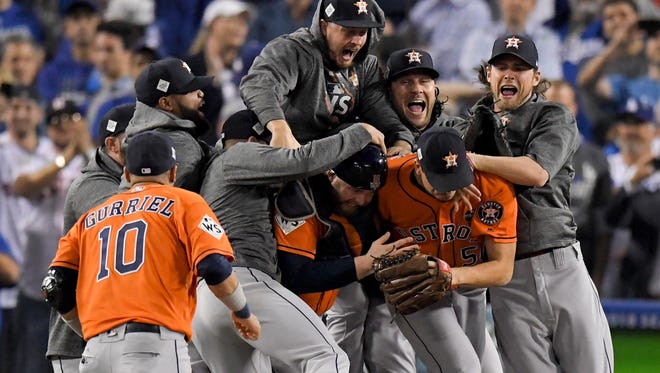 The Houston Astros celebrate after their win against the Los Angeles Dodgers in Game 7 of baseball's World Series Wednesday, Nov. 1, 2017, in Los Angeles. The Astros won 5-1 to win the series 4-3.