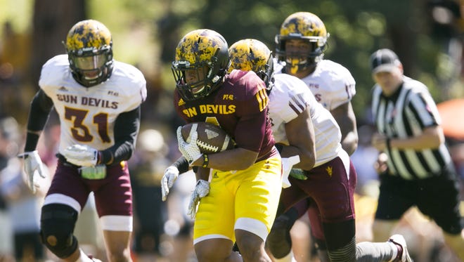 ASU running back Demario Richard carries the ball in front of ASU safety Marcus Ball (31) during an ASU football scrimmage at Camp Tontozona in the Tonto National Forest outside of Payson on August 15, 2015.