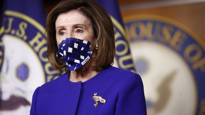 House Speaker Nancy Pelosi of Calif., wears a face mask to protect against the spread of the new coronavirus as she listens to House Majority Whip James Clyburn of S.C., speak during a news conference to announce members of the House Select Committee on the Coronavirus Crisis on Capitol Hill in Washington, Wednesday, April 29, 2020. (AP Photo/Patrick Semansky)