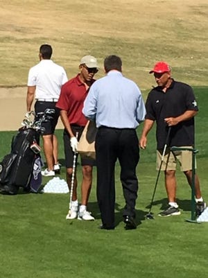 A spectator presents President Barack Obama with a PGA West hat at the Stadium Course on Saturday, Feb. 13, 2016.