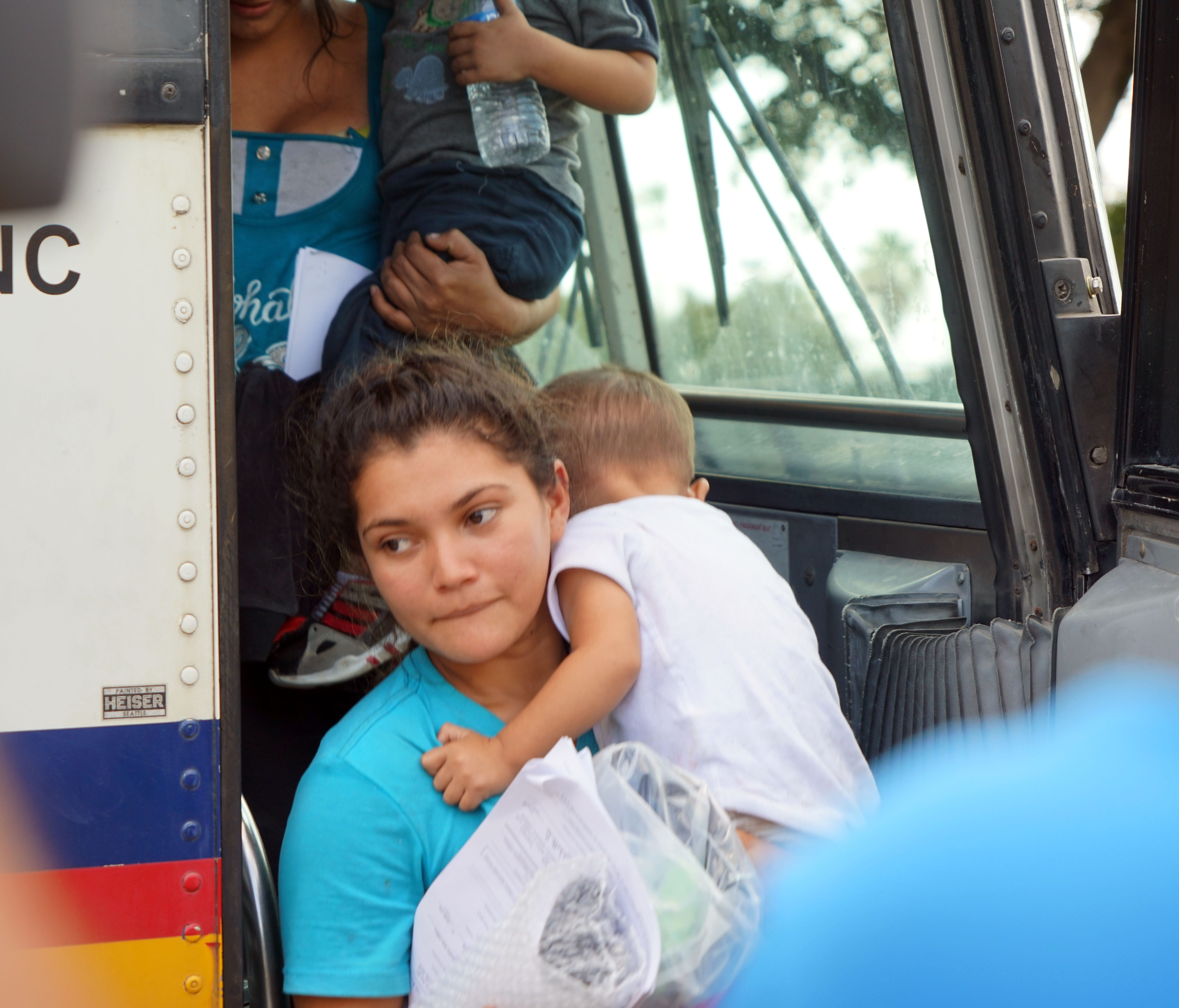 Migrants released from federal custody exit a bus after leaving a federal detention center in McAllen, Texas, on June 22, 2018.