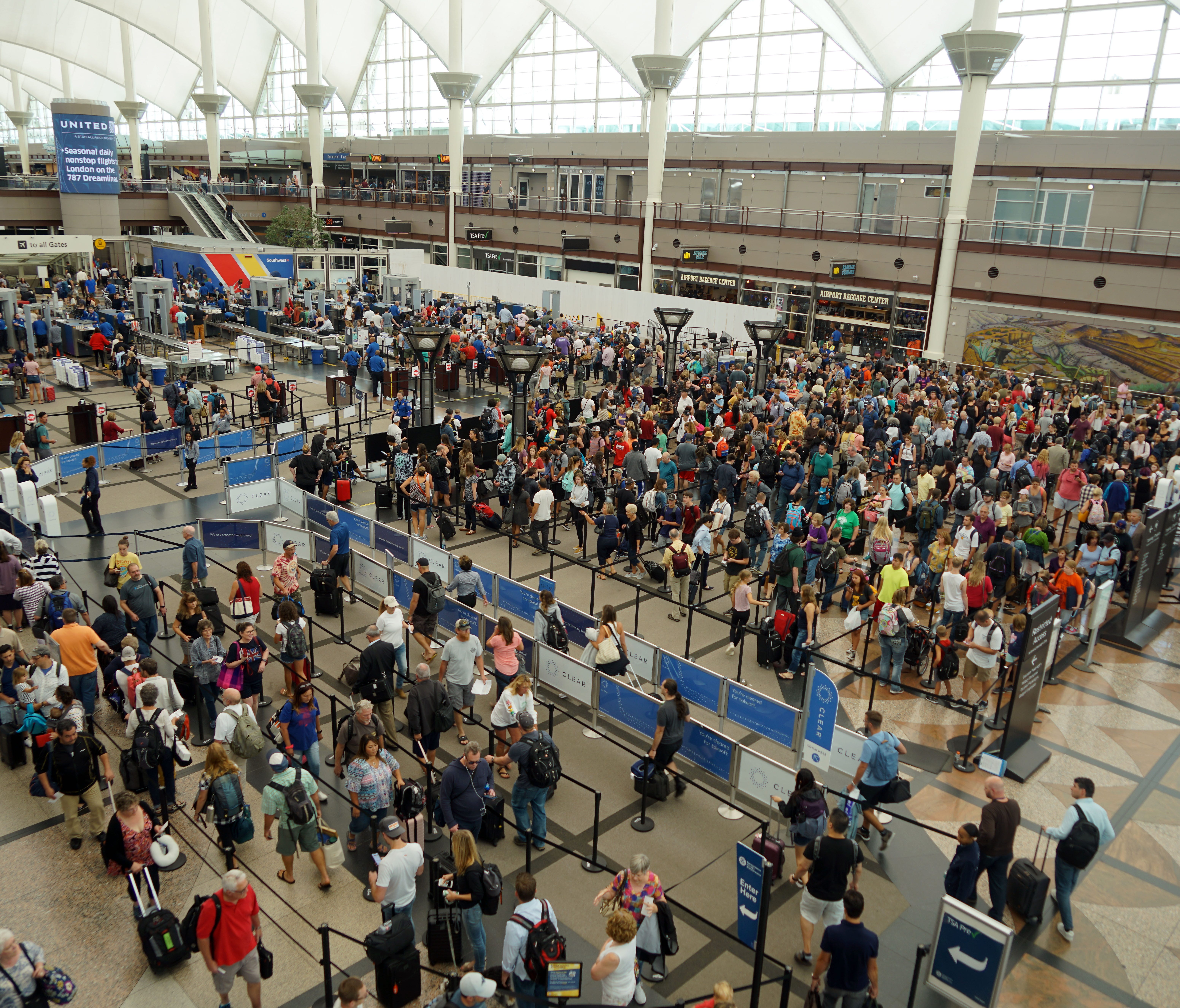 Hundreds of flyers wait in TSA security lines in Denver International Airport's Great Hall. Airport managers have launched a major renovation of the hall, hoping to speed up security screenings and improve the passenger experience.      
