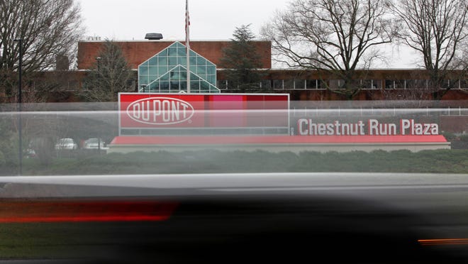 Traffic passes the Chestnut Run headquarters of DuPont Co. on Tuesday. Layoffs announced by the company have reignited calls for an examination of how state finances are handled.