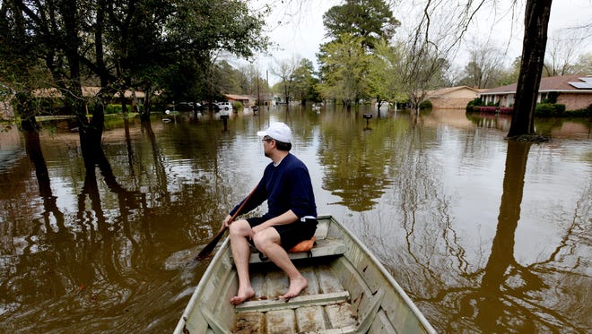 Joe Merendino boats to his house on Dianne Street just south of Caddo Lake in Shreveport, Louisiana.
