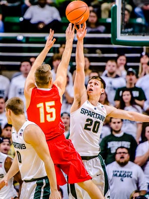 Matt McQuaid ,20, of MSU blocks a shot attempt by Greg Williams of ferris State during their game Monday November 9, 2015 in East Lansing.  KEVIN W. FOWLER PHOTO